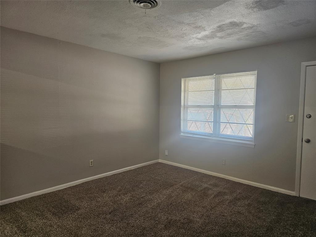 604 East 4th Street Weatherford, TX 76086 - Photo 3 of 20 an empty room with a empty space and window