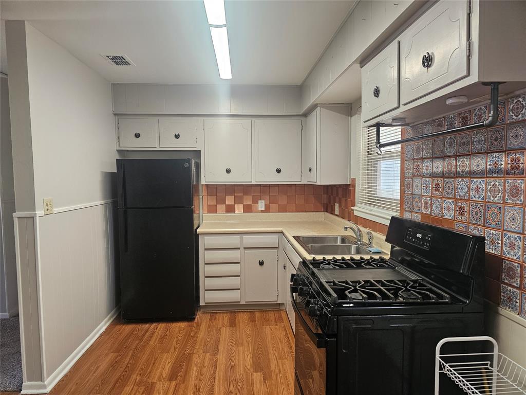 604 East 4th Street Weatherford, TX 76086 - Photo 5 of 20 a kitchen with a stove and a refrigerator