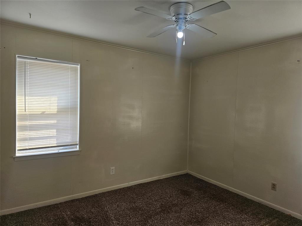 604 East 4th Street Weatherford, TX 76086 - Photo 9 of 20 an empty room with a window and a fan