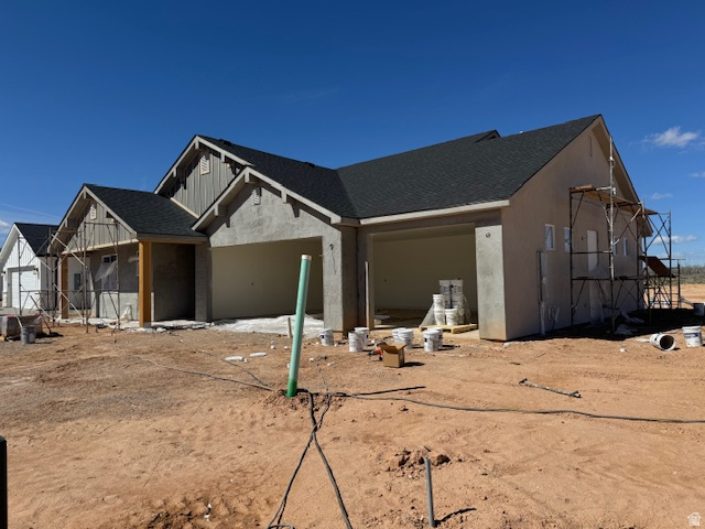 5005 North 75 East Enoch, UT 84721 - Photo 5 of 37 View of front of house featuring roof with shingles, board and batten siding, and stucco siding