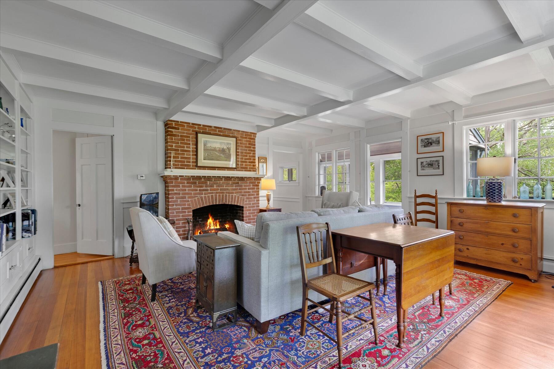 21 Quaker Road East Sandwich, MA 02537 - Photo 10 of 43 a living room with furniture a table and a fireplace