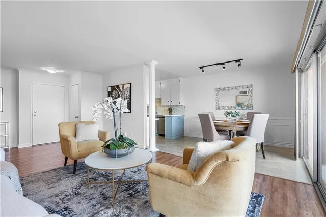 a living room with furniture a table and chair