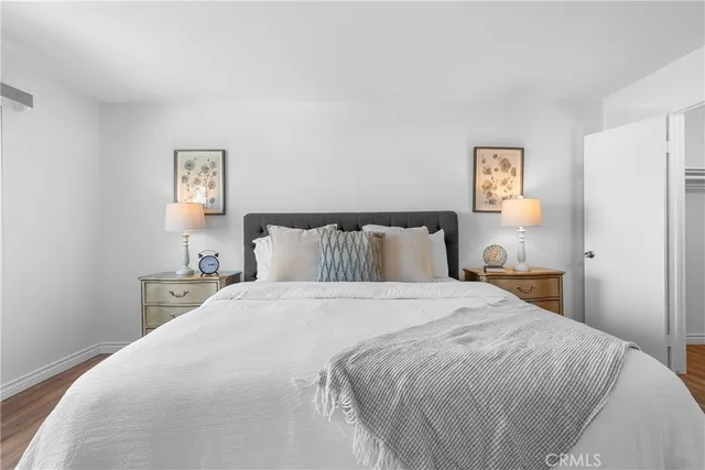 a bedroom with a bed and painting on the wall