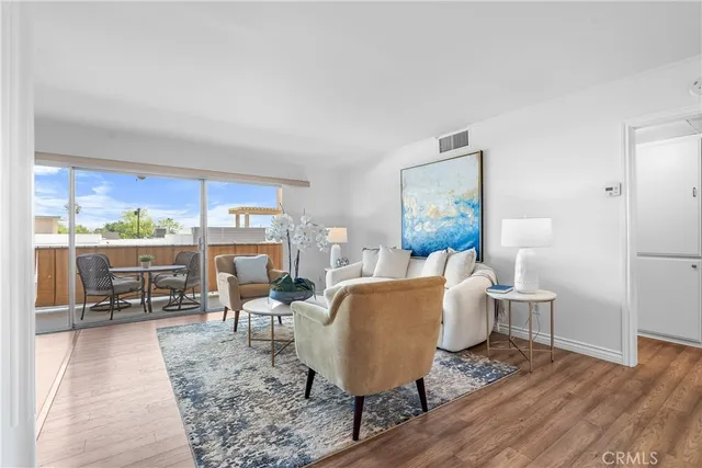 a living room with furniture a rug and a table