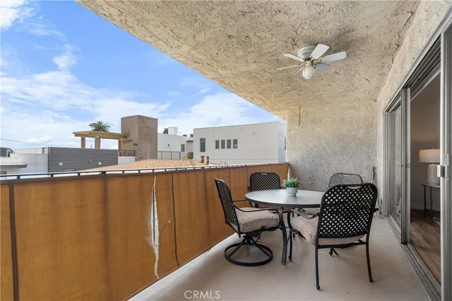 a balcony with table and chairs