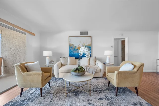 a living room with furniture and a potted plant