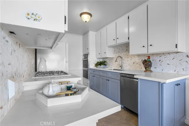 a kitchen with stainless steel appliances kitchen island granite countertop a sink and cabinets