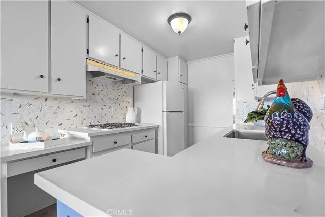 a kitchen with stainless steel appliances kitchen island granite countertop a refrigerator and a stove