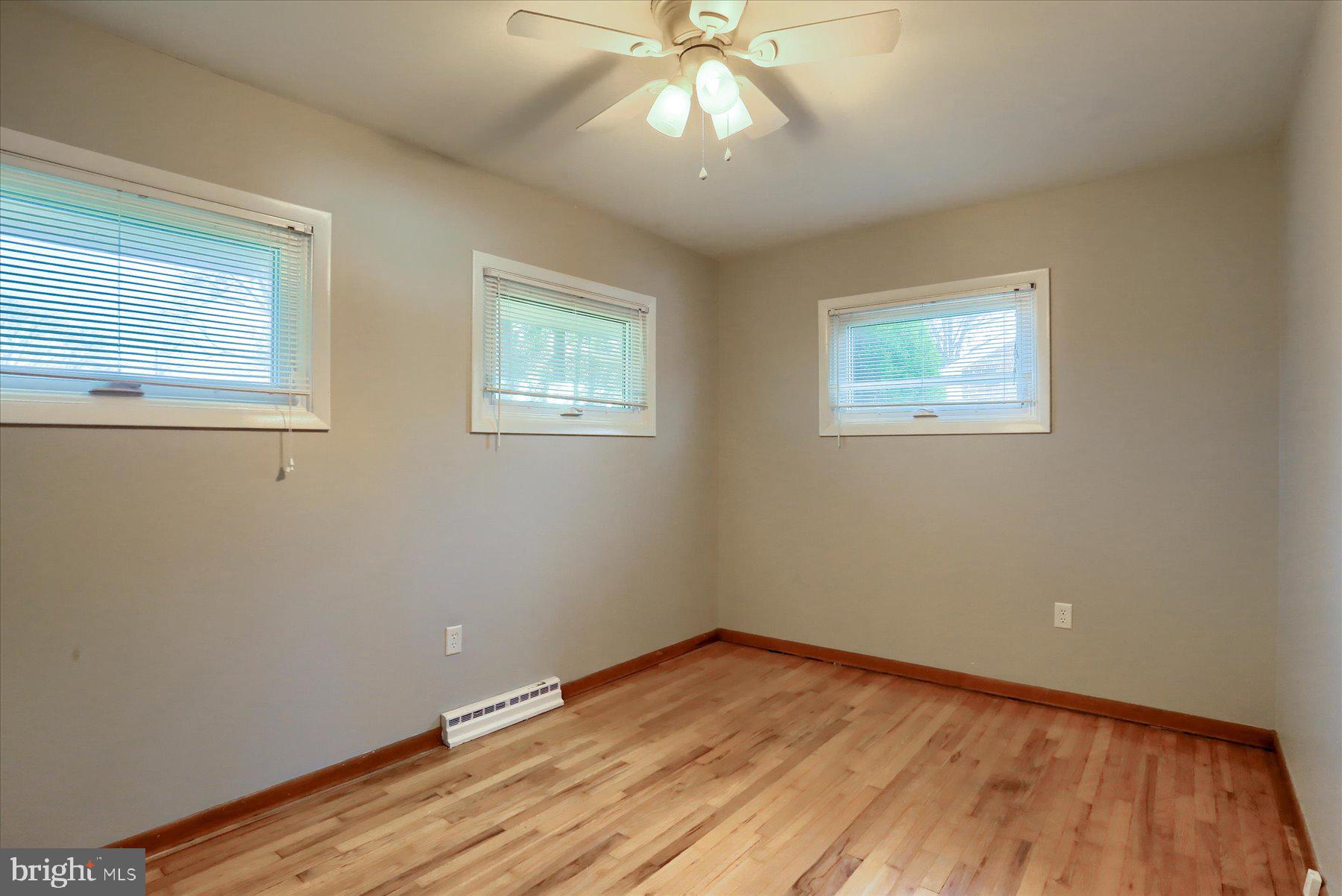 3240 Cloverfield Road Harrisburg, PA 17109 - Photo 12 of 28 a view of an empty room with wooden floor and a window