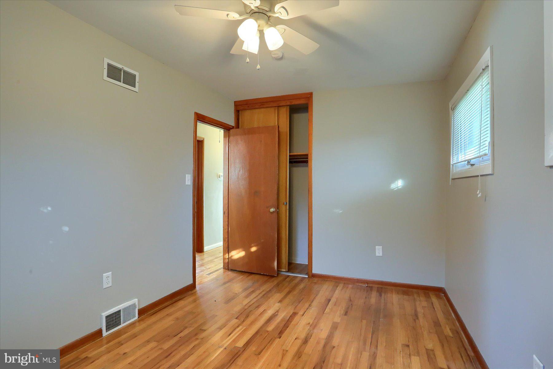 3240 Cloverfield Road Harrisburg, PA 17109 - Photo 13 of 28 a view of an empty room with wooden floor and fan