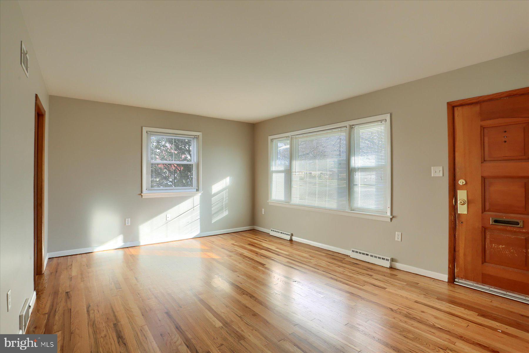 3240 Cloverfield Road Harrisburg, PA 17109 - Photo 4 of 28 an empty room with wooden floor and windows