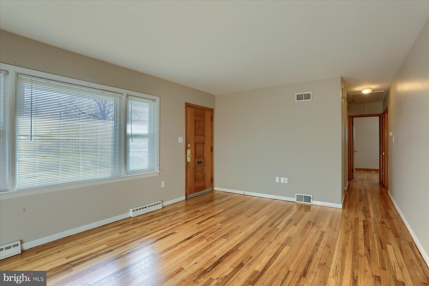 3240 Cloverfield Road Harrisburg, PA 17109 - Photo 6 of 28 a view of an empty room with wooden floor and a window
