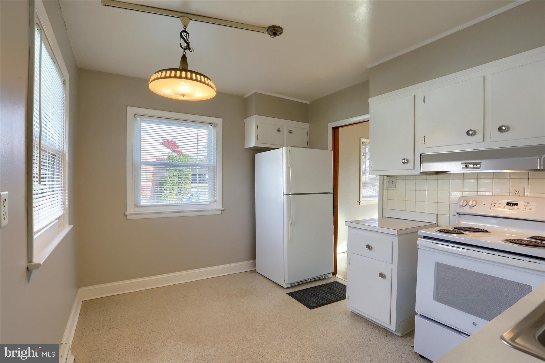 3240 Cloverfield Road Harrisburg, PA 17109 - Photo 8 of 28 a kitchen with a refrigerator and a stove top oven