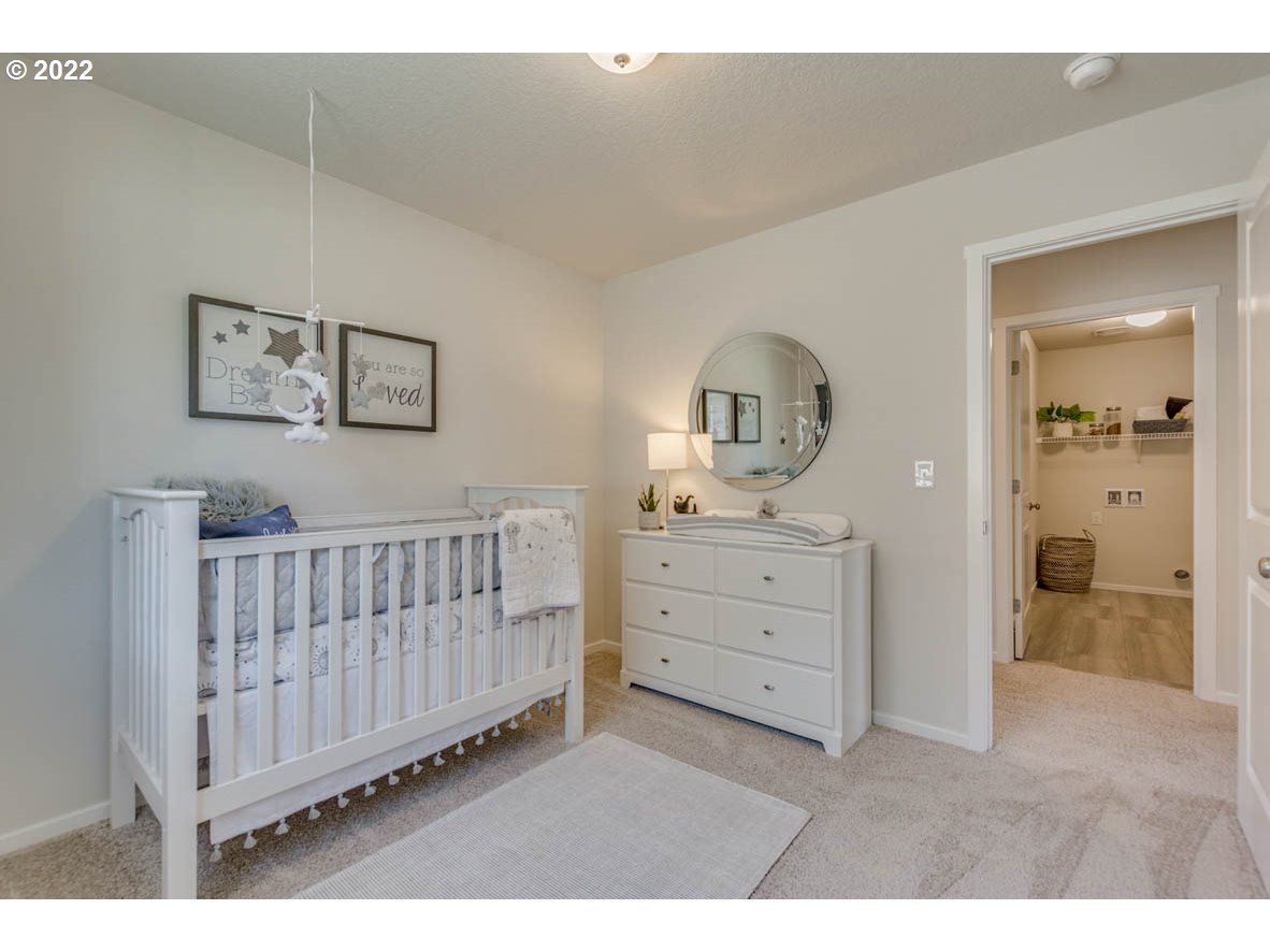 2866 Pierce Parkway Springfield, OR 97477 - Photo 9 of 14 a room with a baby crib dresser and a window