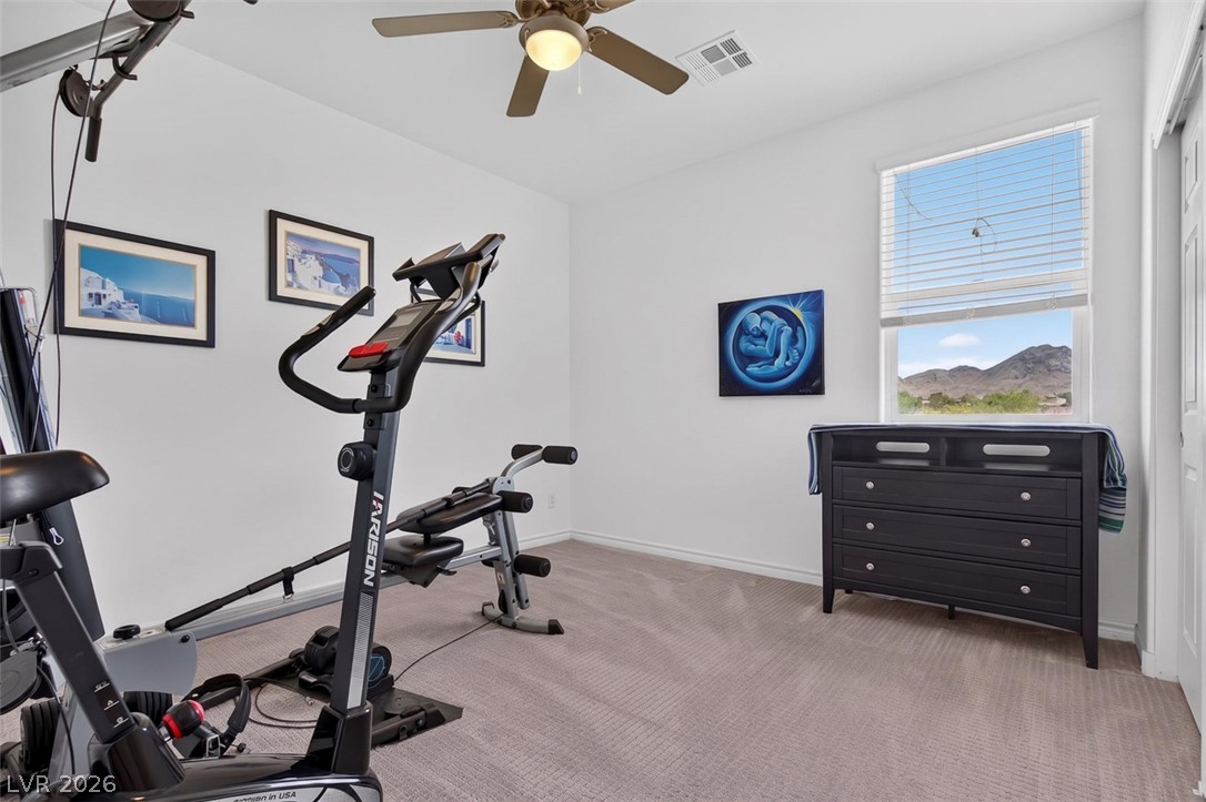 1824 Redland Ridge Street Henderson, NV 89002 - Photo 50 of 69 A dedicated home gym space, featuring light-colored walls and carpet, offers a serene workout environment.