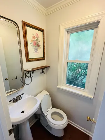 a bathroom with a toilet a sink and a mirror