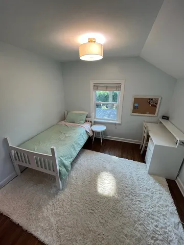 a living room with a bed furniture and a window