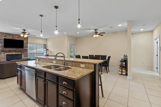 a kitchen with a sink a counter top space appliances and cabinets