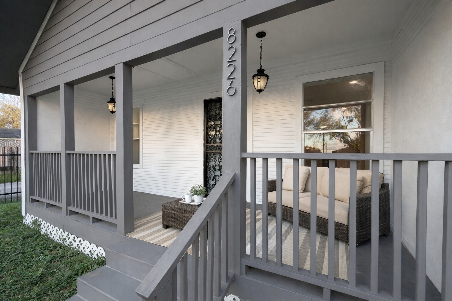 a view of a balcony with wooden floor and fence