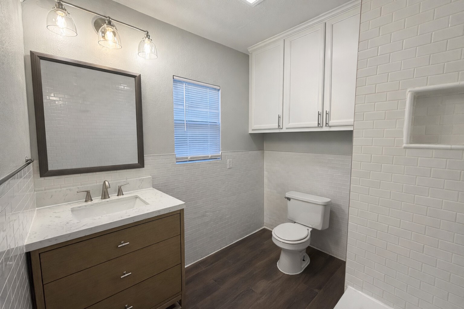 8226 Harding Street Houston, TX 77012 - Photo 11 of 13 a bathroom with a toilet a sink and mirror