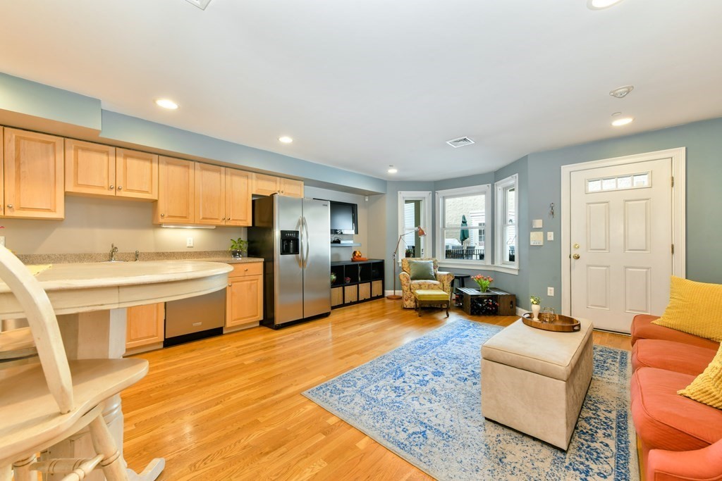 2 Lee Hill Road, Unit 6 Boston, MA 02131 - Photo 11 of 42 a large living room with stainless steel appliances granite countertop furniture and a kitchen view