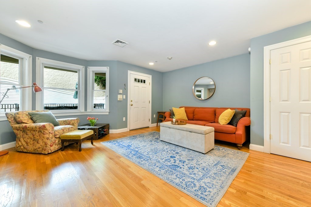 2 Lee Hill Road, Unit 6 Boston, MA 02131 - Photo 12 of 42 a living room with furniture and a rug
