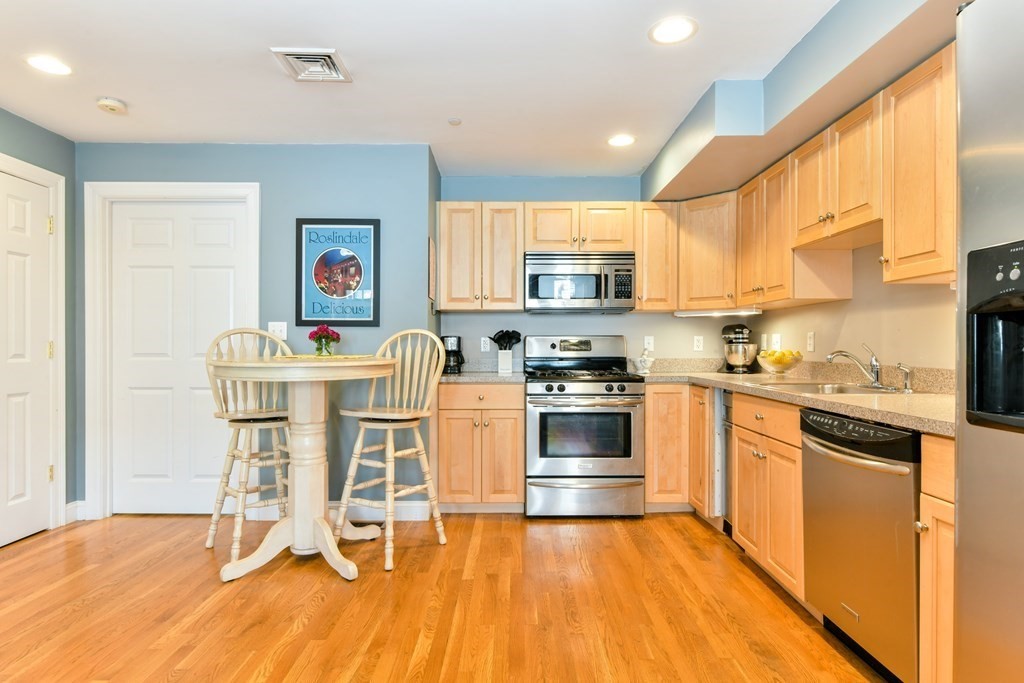2 Lee Hill Road, Unit 6 Boston, MA 02131 - Photo 14 of 42 a kitchen with a sink cabinets and wooden floor