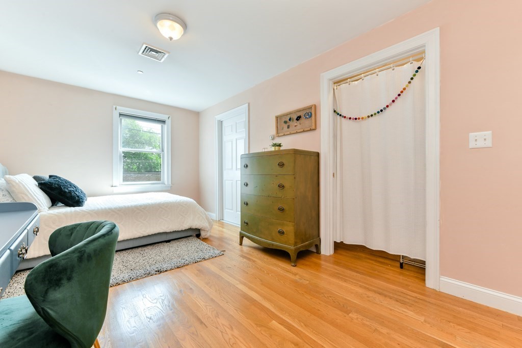 2 Lee Hill Road, Unit 6 Boston, MA 02131 - Photo 15 of 42 a bedroom with a bed and a mirror