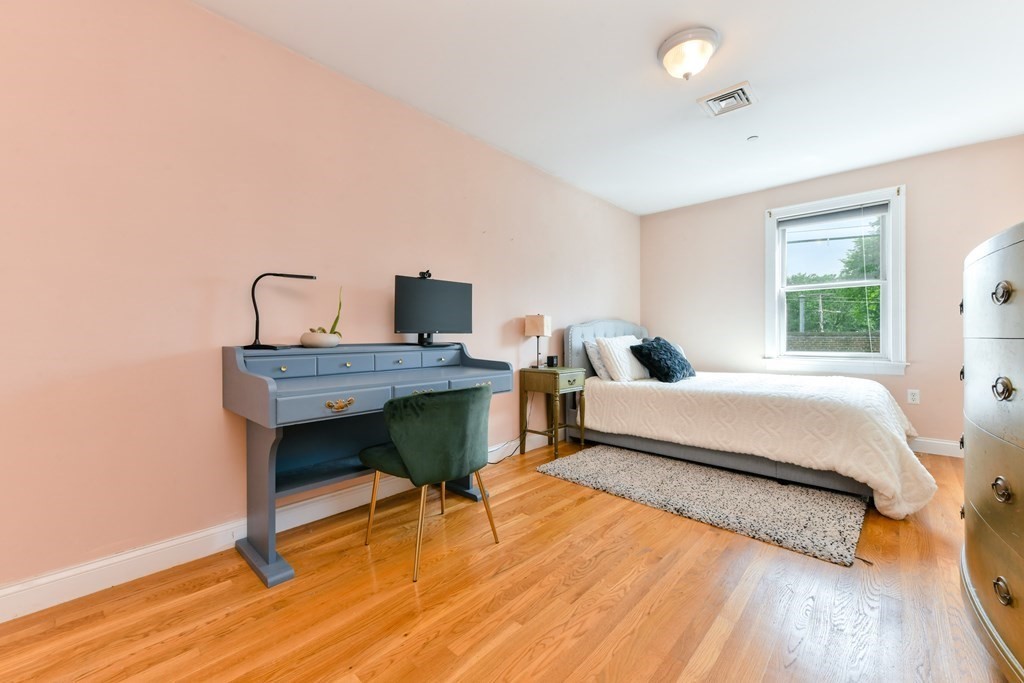2 Lee Hill Road, Unit 6 Boston, MA 02131 - Photo 16 of 42 a bedroom with a bed and a table