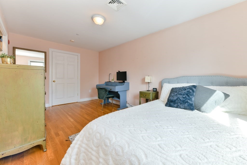 2 Lee Hill Road, Unit 6 Boston, MA 02131 - Photo 17 of 42 a bedroom with a bed and a desk