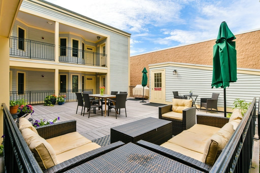2 Lee Hill Road, Unit 6 Boston, MA 02131 - Photo 20 of 42 a view of a patio with chairs and tables