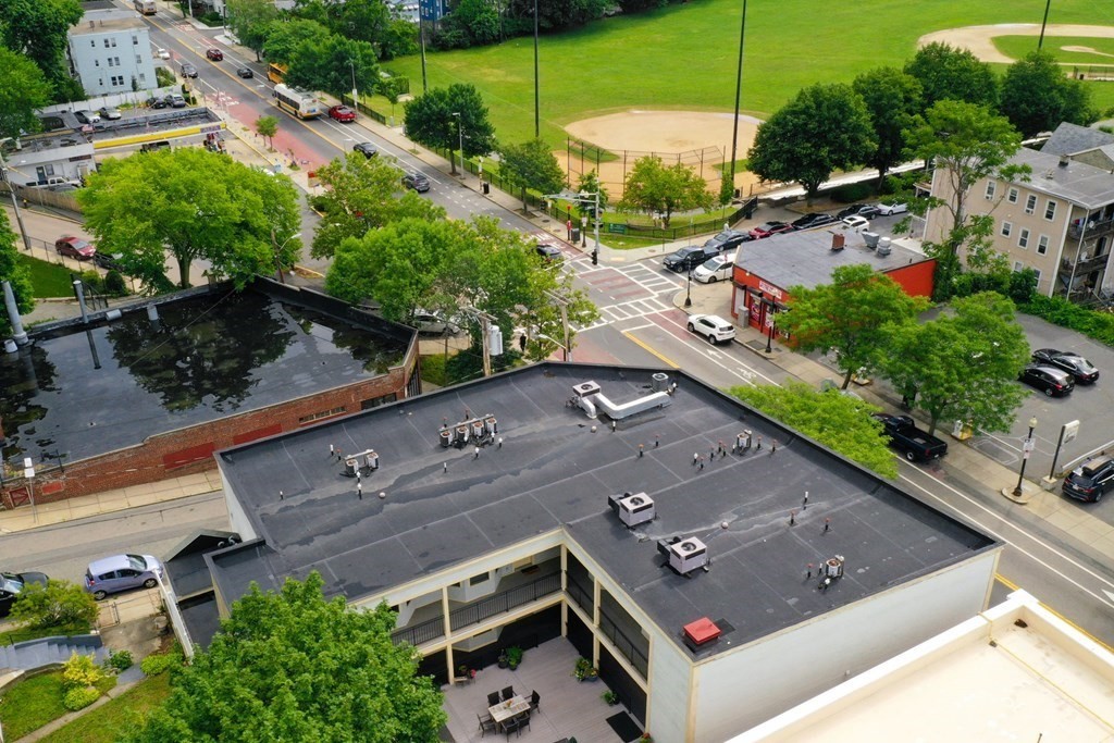2 Lee Hill Road, Unit 6 Boston, MA 02131 - Photo 27 of 42 a aerial view of a house with a garden