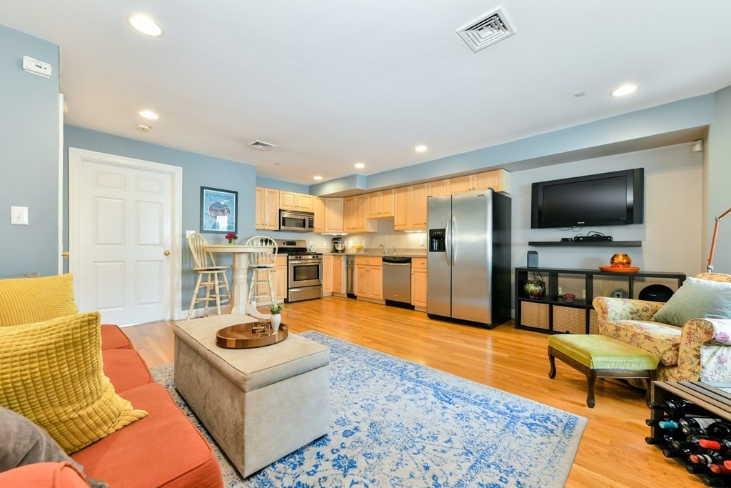 2 Lee Hill Road, Unit 6 Boston, MA 02131 - Photo 4 of 42 a living room with furniture and a flat screen tv