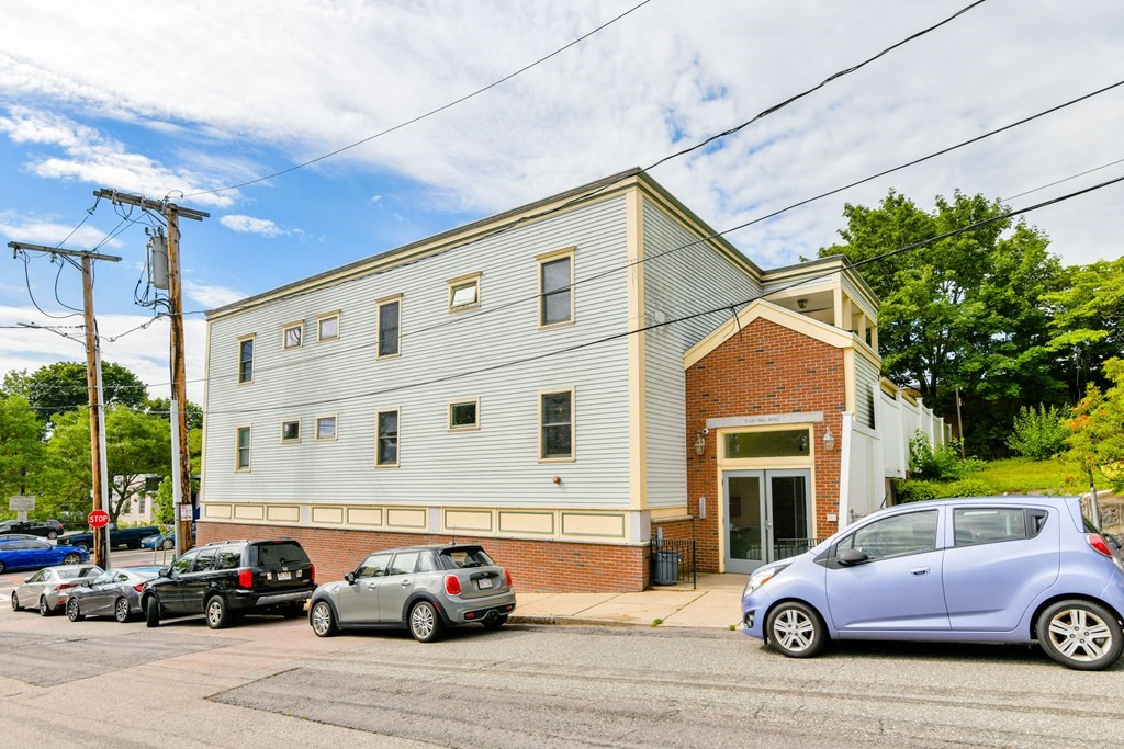2 Lee Hill Road, Unit 6 Boston, MA 02131 - Photo 41 of 42 a car parked in front of a house