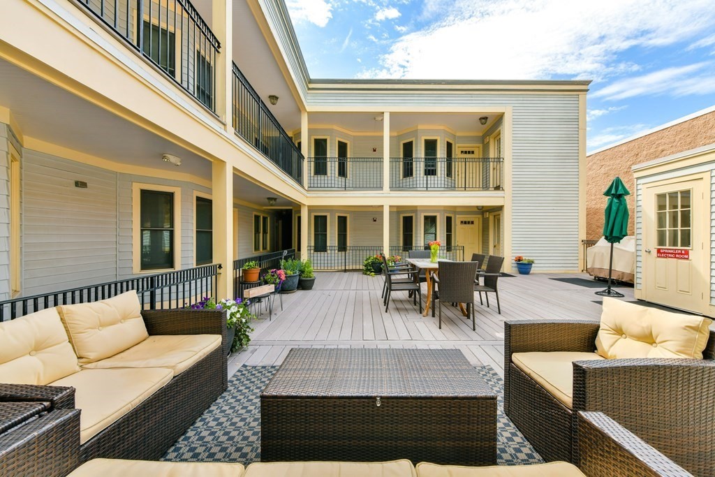 2 Lee Hill Road, Unit 6 Boston, MA 02131 - Photo 7 of 42 a view of a patio with couches table and chairs and potted plants