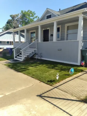 a view of a house with pool and deck in the background