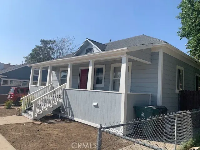 a front view of a house with iron fence