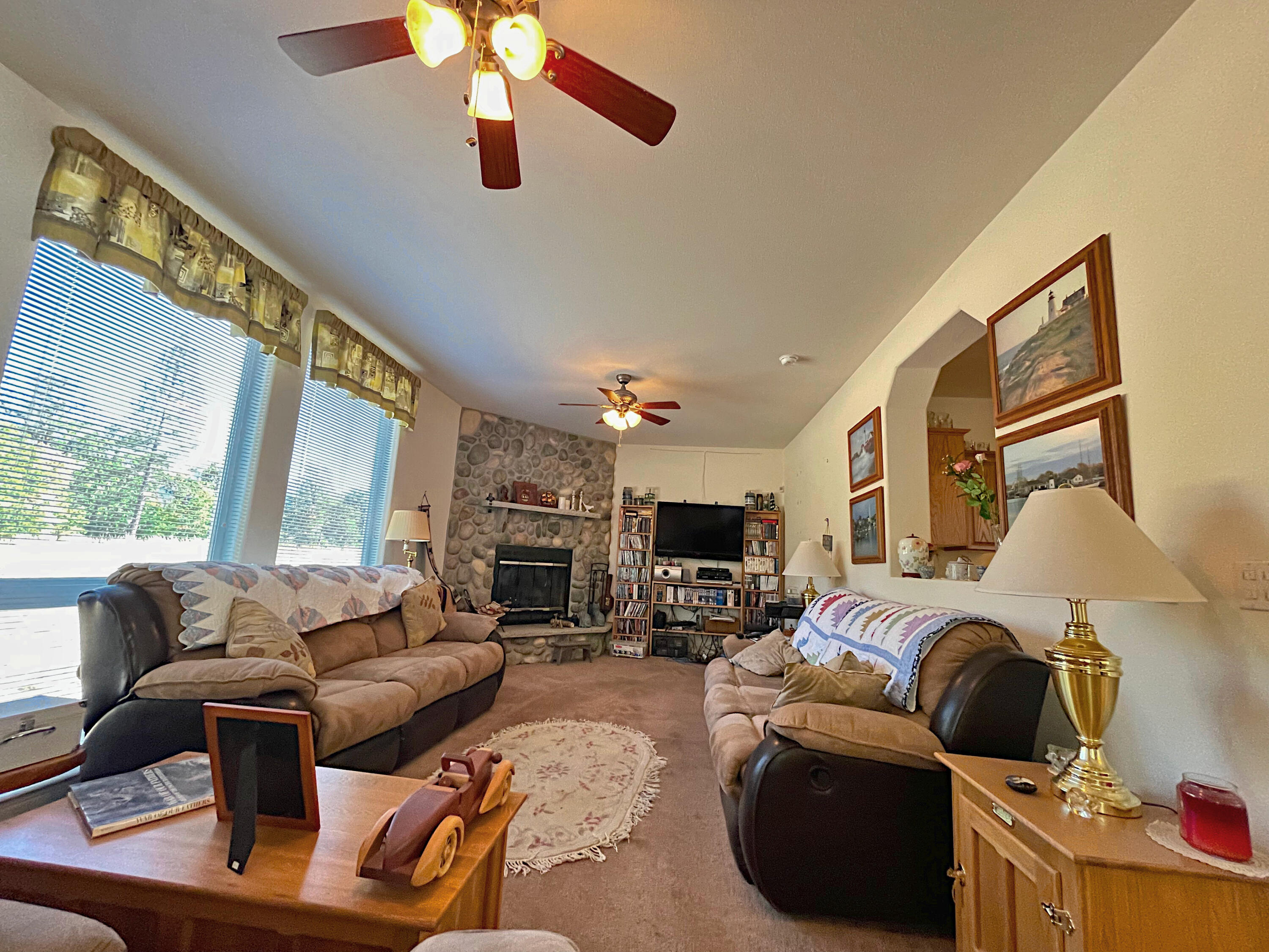 4911 Rockydale Road Cave Junction, OR 97523 - Photo 17 of 25 a living room with furniture fireplace and a large window