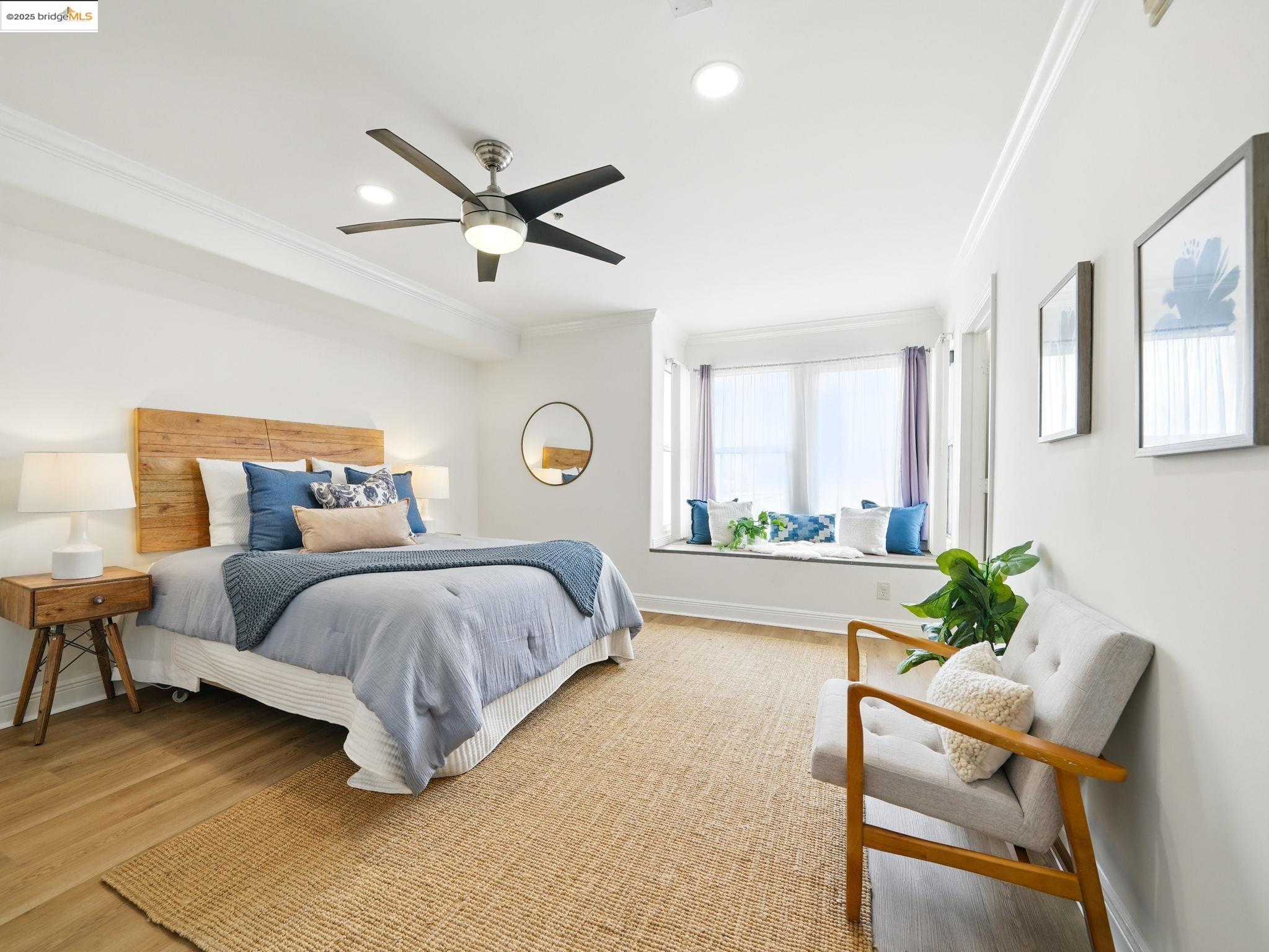 1515 14th Avenue, Unit 201 Oakland, CA 94606 - Photo 1 of 23 a spacious bedroom with a bed and a large window