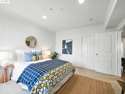 a bedroom with a bed and lamp next to a window