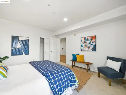 a bedroom with a bed and a chair