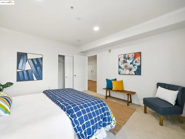 a bedroom with a bed and a chair