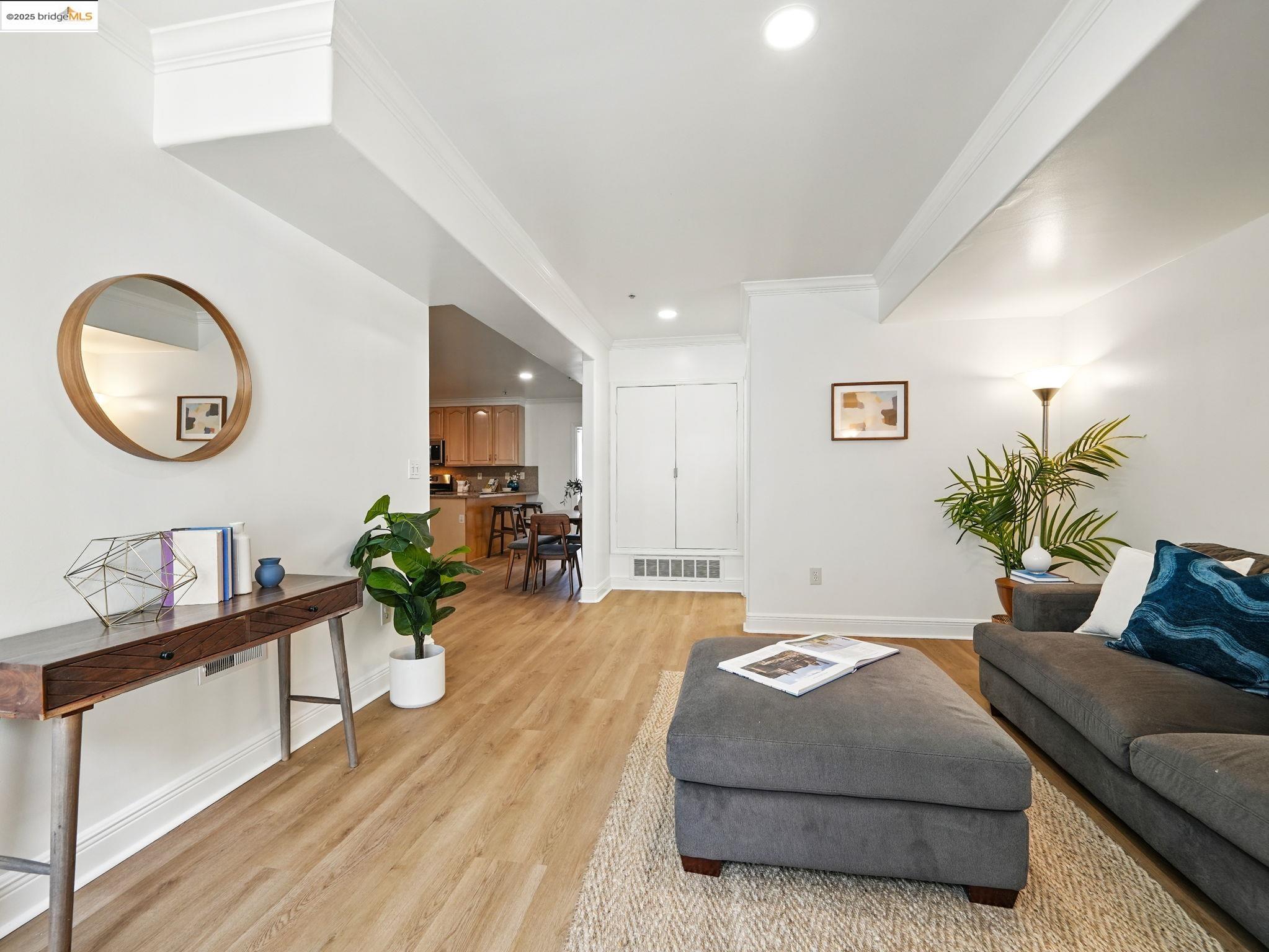 1515 14th Avenue, Unit 201 Oakland, CA 94606 - Photo 4 of 23 a living room with furniture and a potted plant