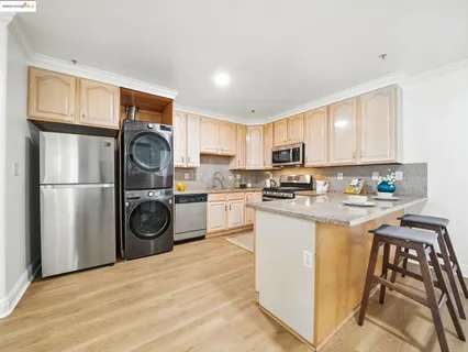 a kitchen with refrigerator a stove a washer and dryer