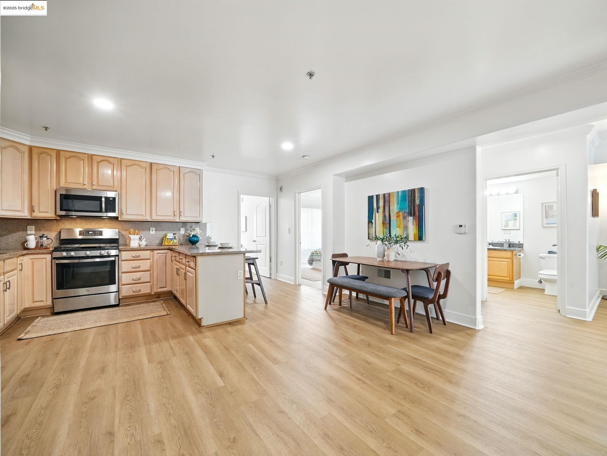 1515 14th Avenue, Unit 201 Oakland, CA 94606 - Photo 8 of 23 a kitchen with a table and chairs in it