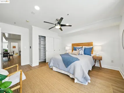 a bedroom with a bed and wooden floor