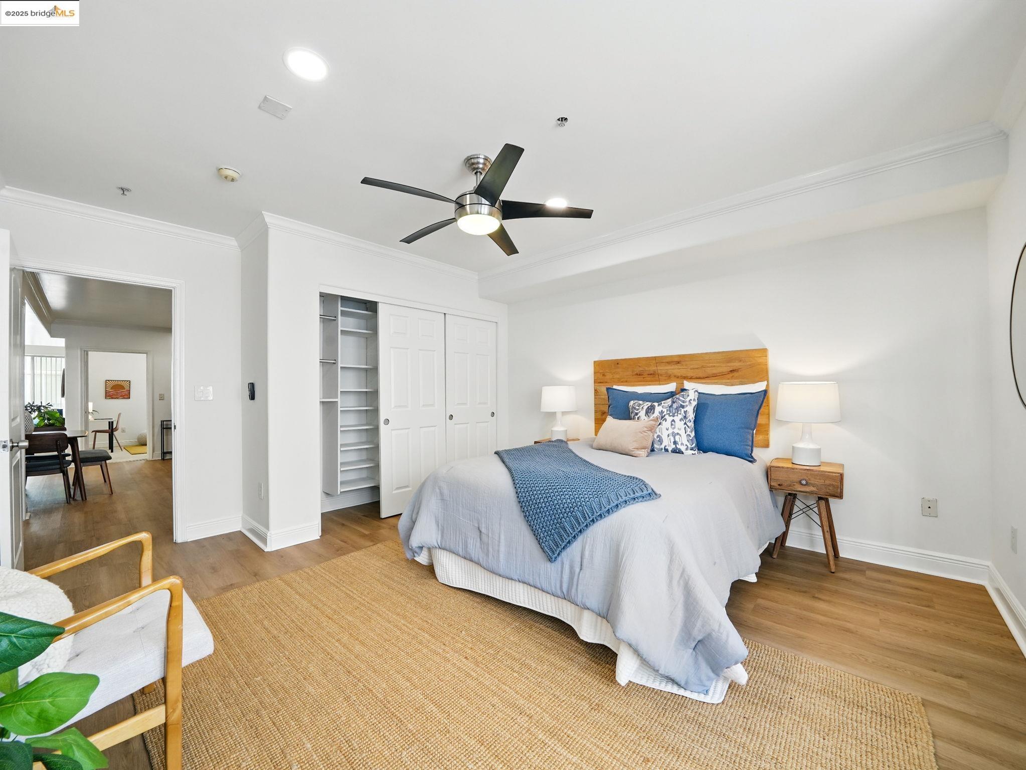 1515 14th Avenue, Unit 201 Oakland, CA 94606 - Photo 10 of 23 a bedroom with a bed and wooden floor