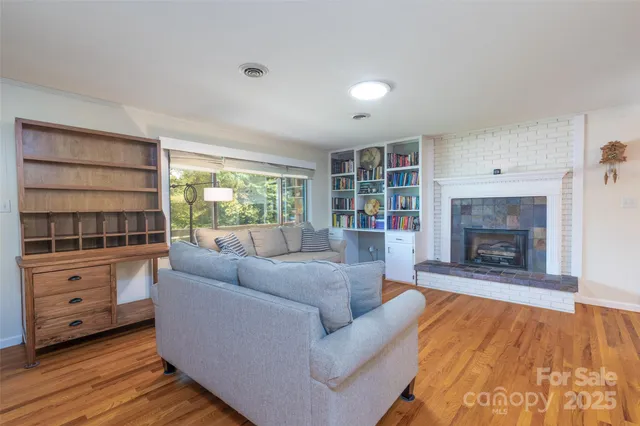 a living room with furniture and a fireplace