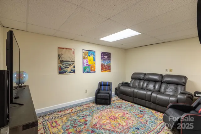a living room with furniture and a clock