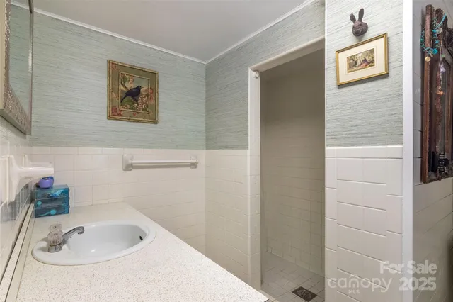 a view of a house with table and chairs next to a yard